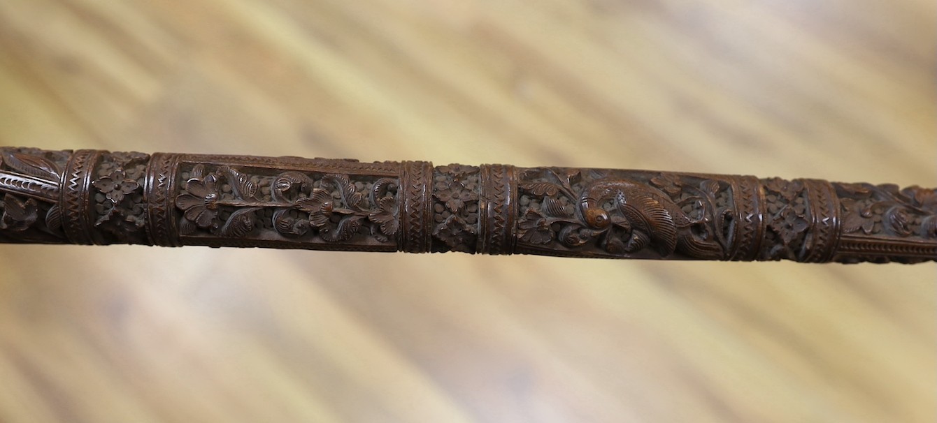 An Asian carved wood walking cane, 7 cm long.